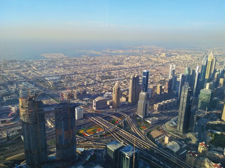 an aerial view of a city that has tracks in the foreground