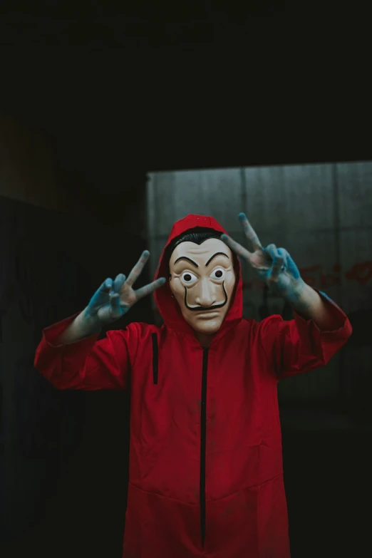 a person in a red hoodie with a face painted on