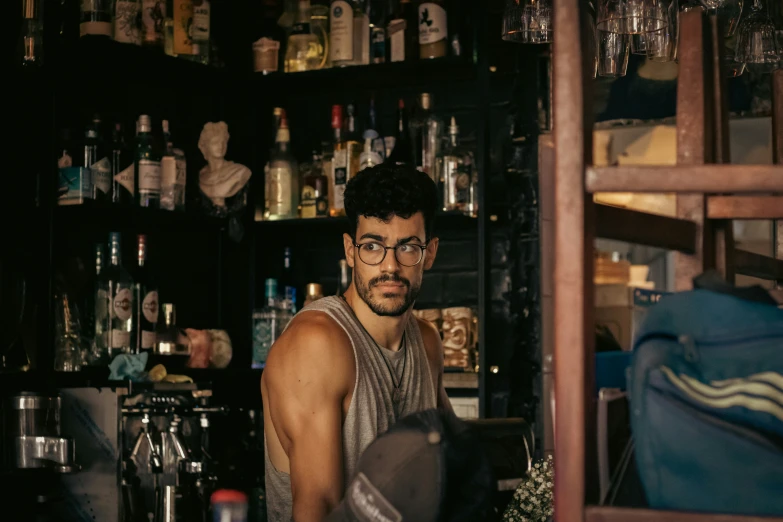 man at the bar with drinks, looking up and smiling