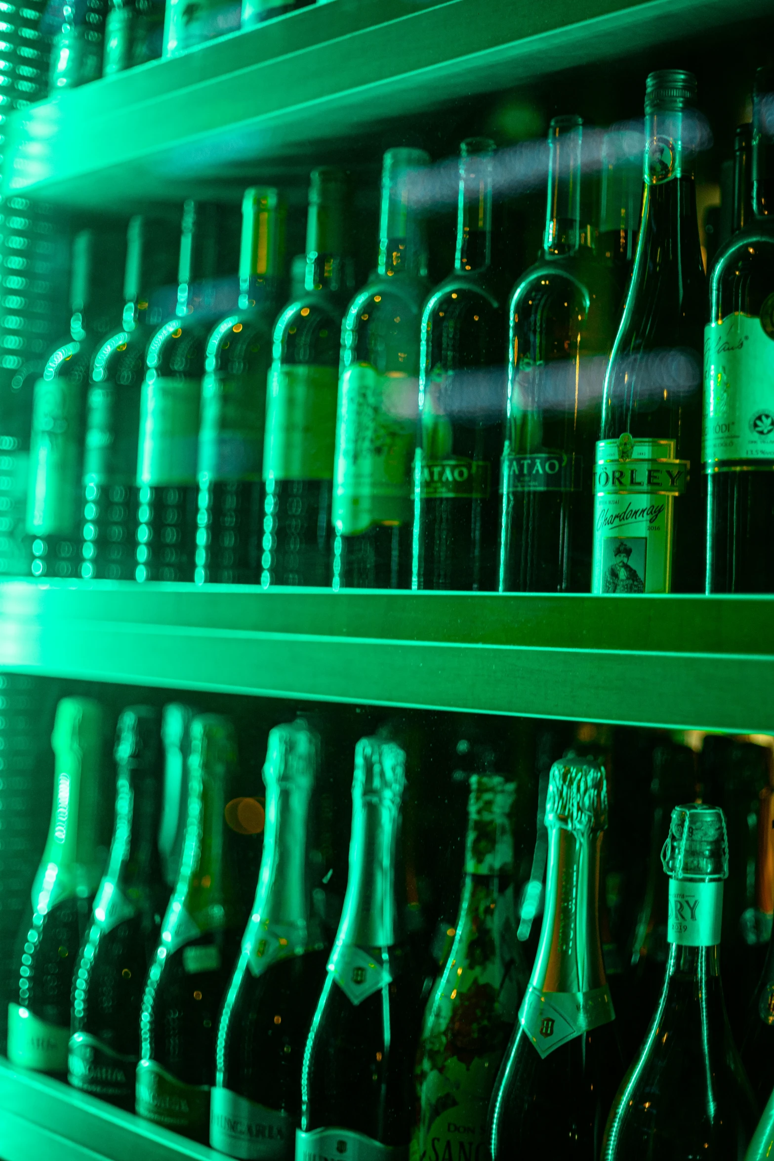 various bottles of wine sitting on shelves in a room