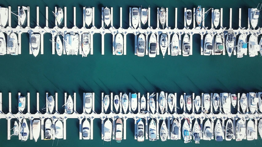 aerial view of white boats parked at a dock in the water