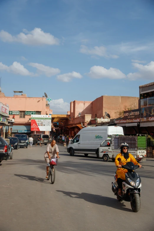 people on motorcycles travel down the street of the old town