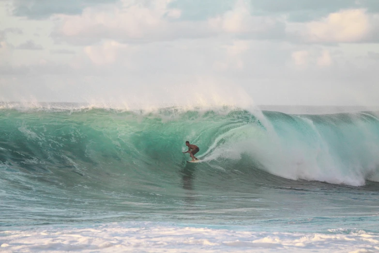 a surfer in the middle of a large wave