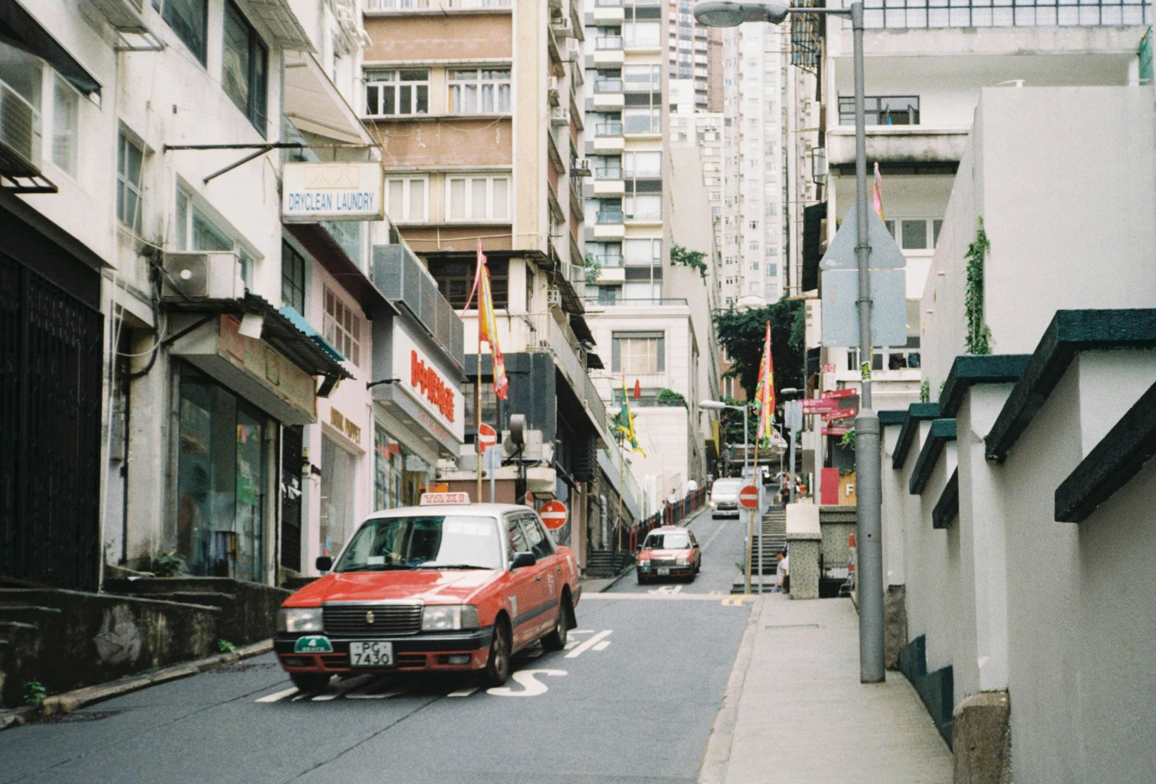 a red van that is sitting in front of buildings