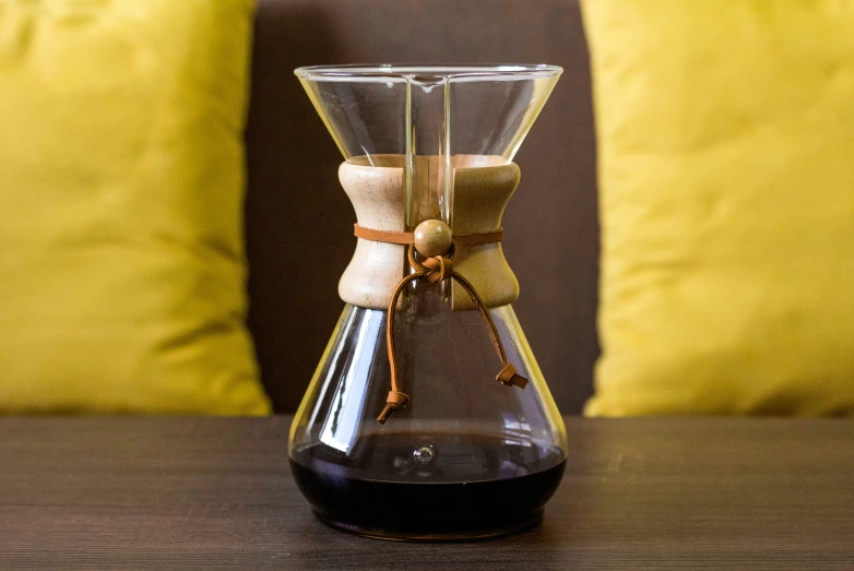 a coffee maker made with sand and wooden sticks