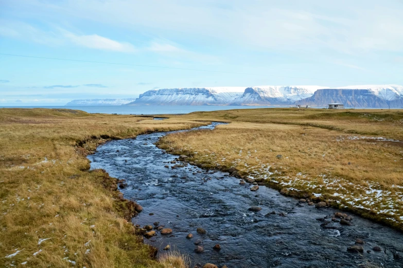 the long stretch of stream winds through the meadow