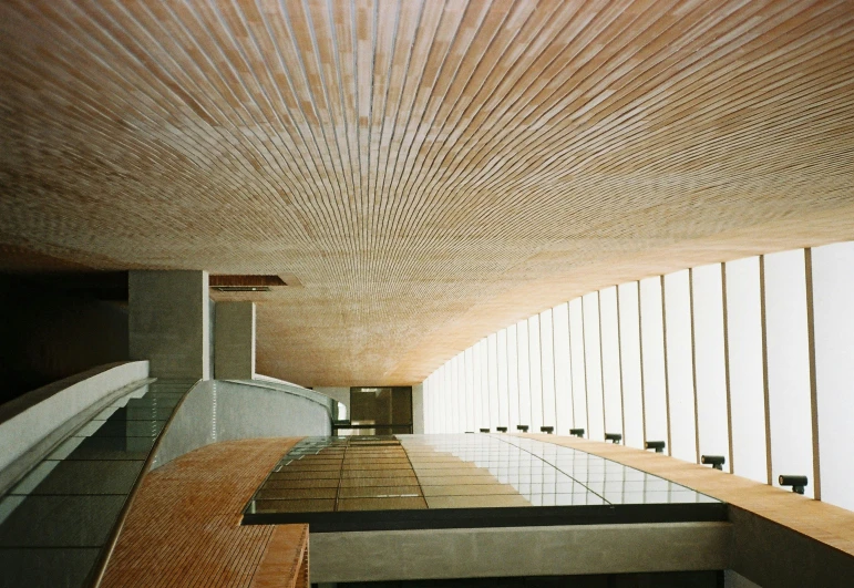 a wooden ceiling with many windows and wood bars