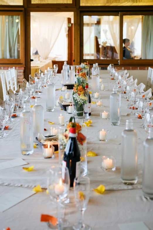 a table has vases and candles on it