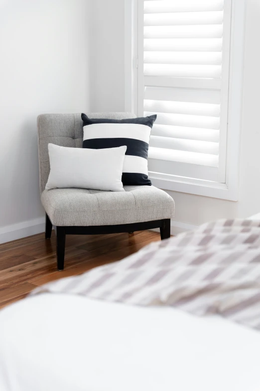 black and white pillows sitting on top of a chair