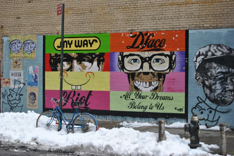 street art showing three men's faces and different words