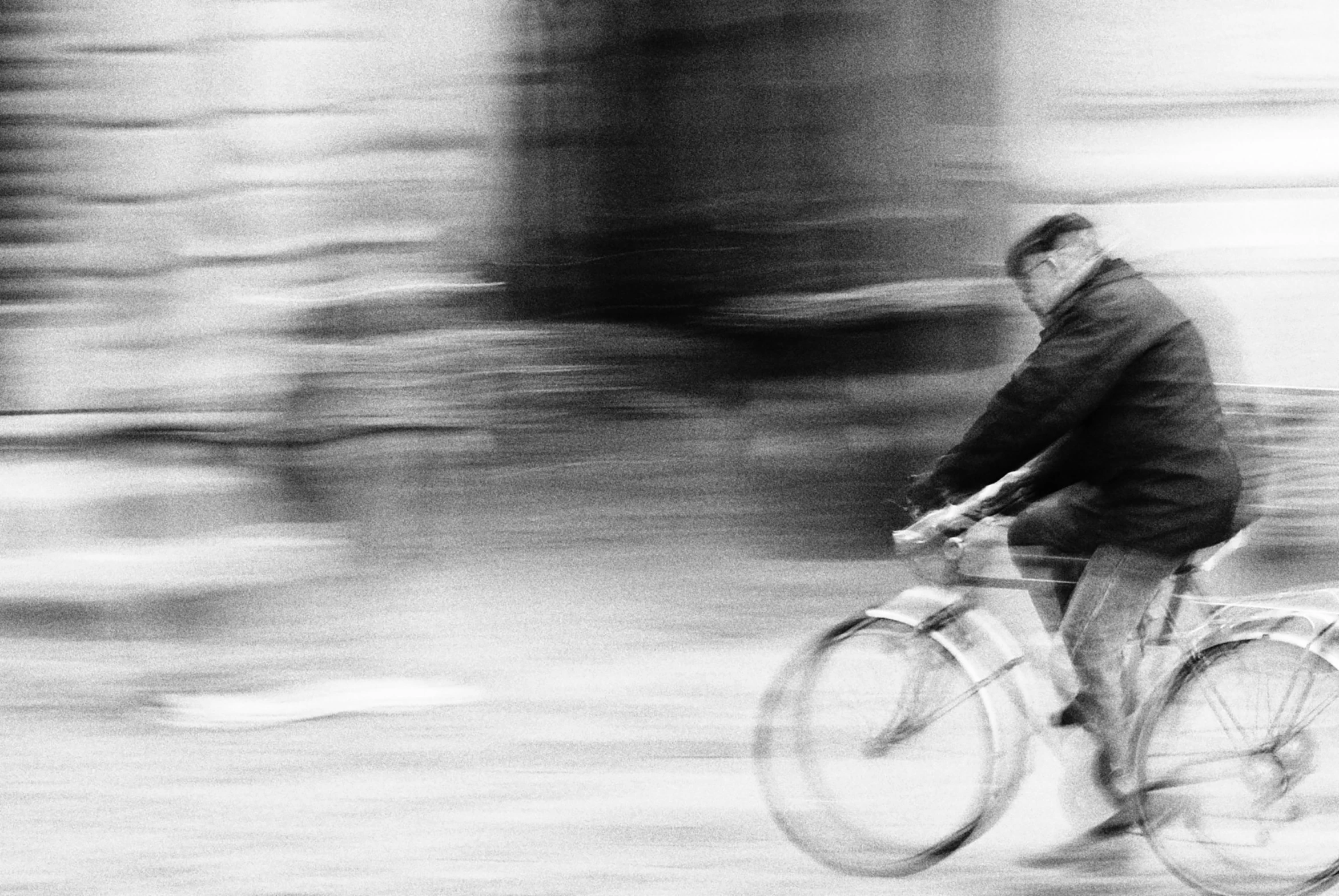 a blurry pograph of a person on a bike