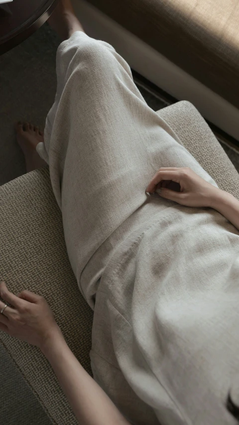 a woman sitting on the floor with her feet on the couch