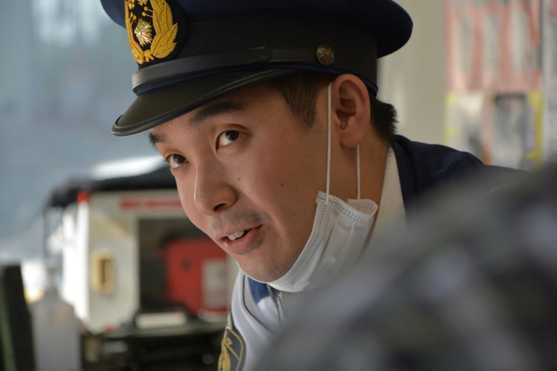 a man is wearing a uniform and listening to a man