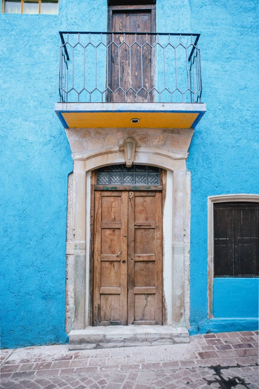 a doorway in an old style building with a balcony