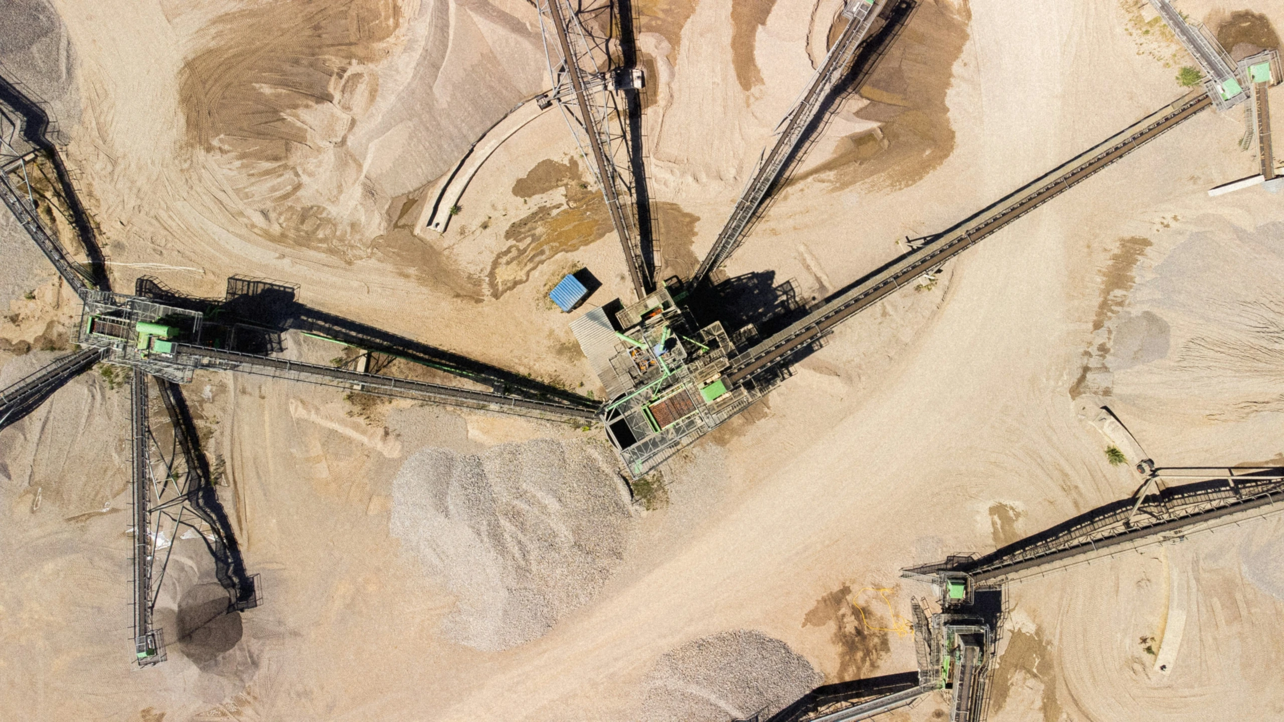 an overhead view of a large field and rail road tracks