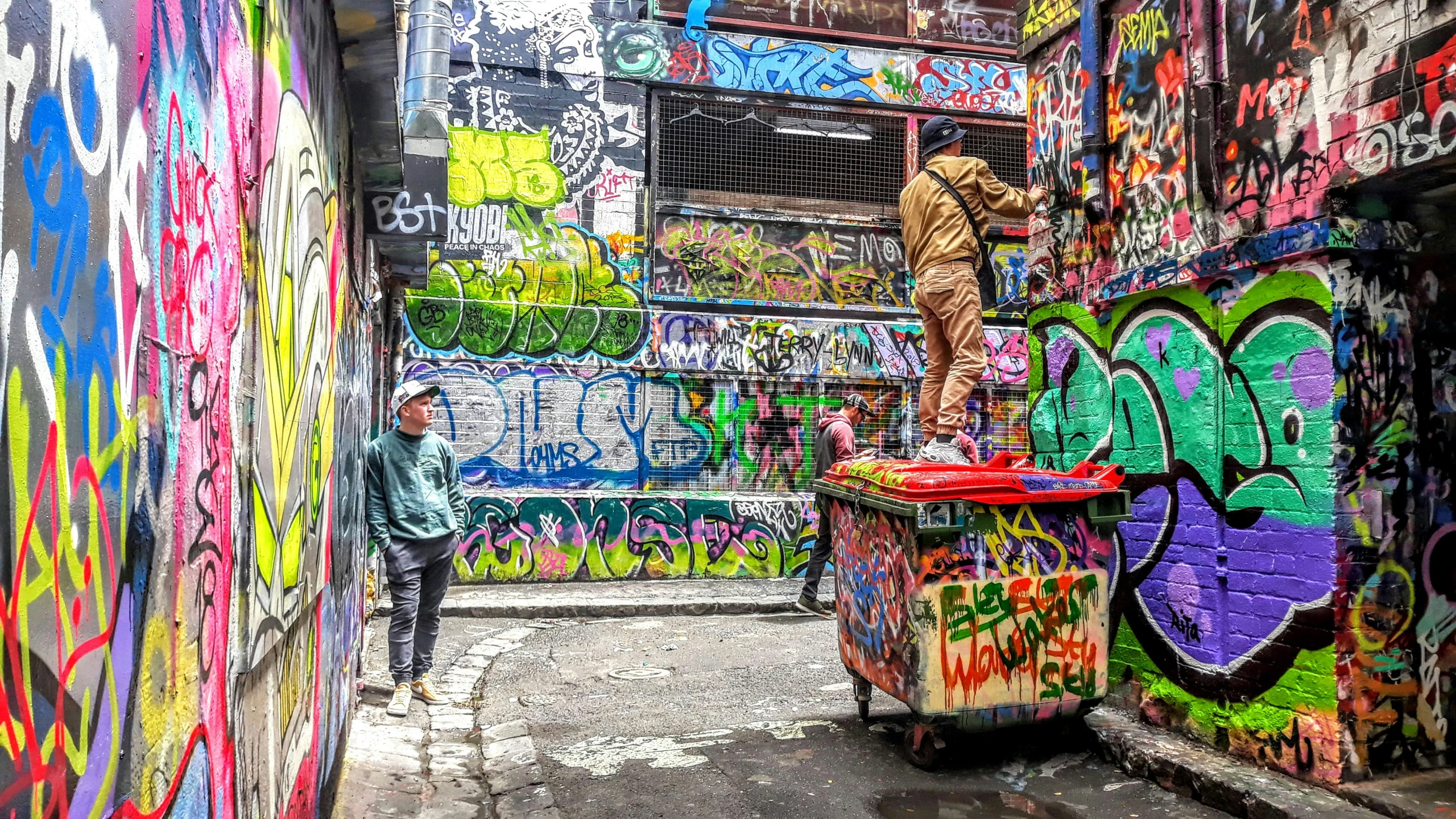 a guy is painting a mural on a building