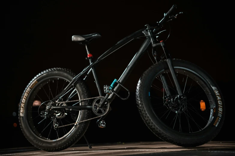 a mountain bike is lit up against a dark background