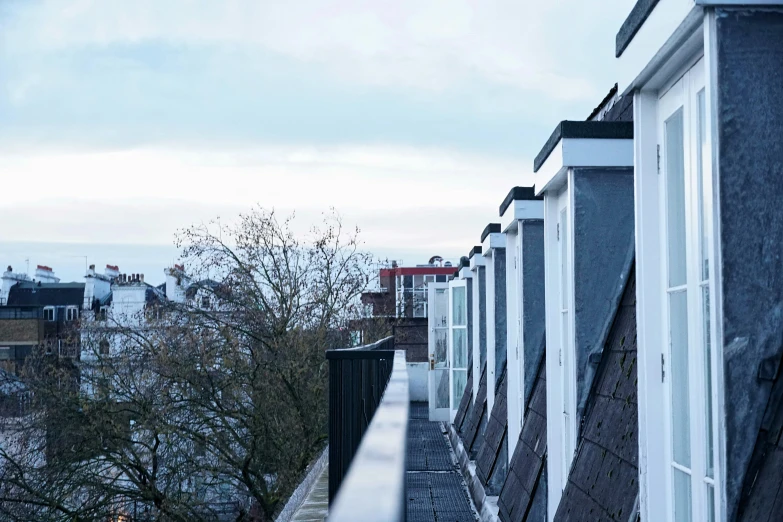 an empty balcony with a view of the city