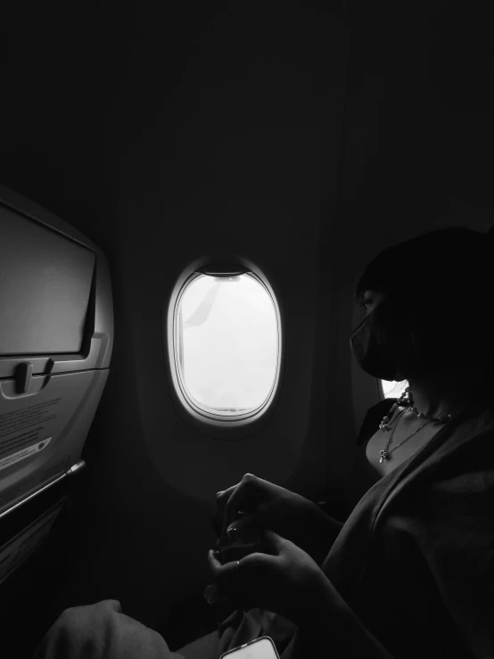 a man looking out the window of an airplane