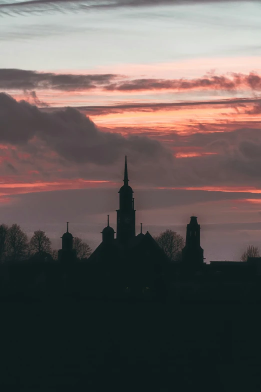 a tower on top of a building with clouds above