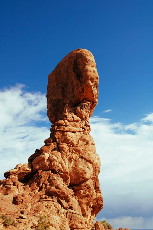 a rock formation sitting in the middle of desert