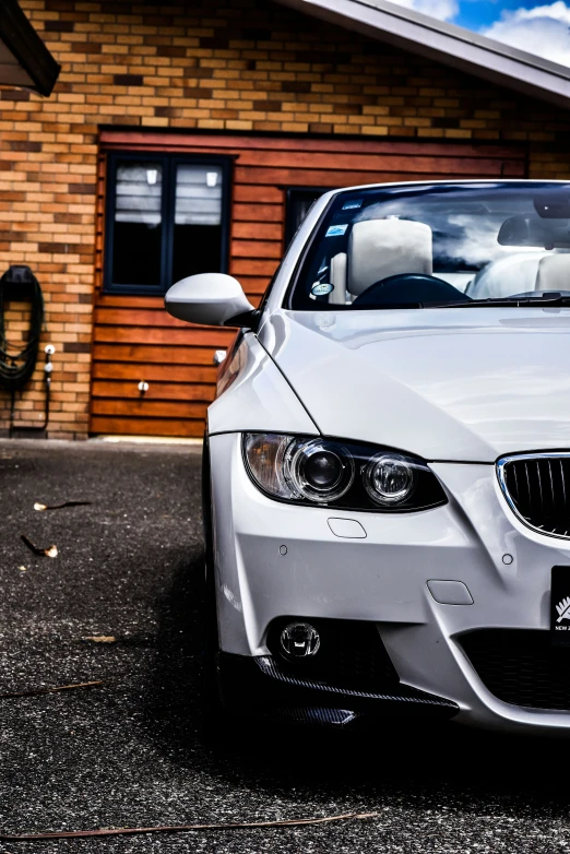 a bmw car parked in front of a brown wooden building