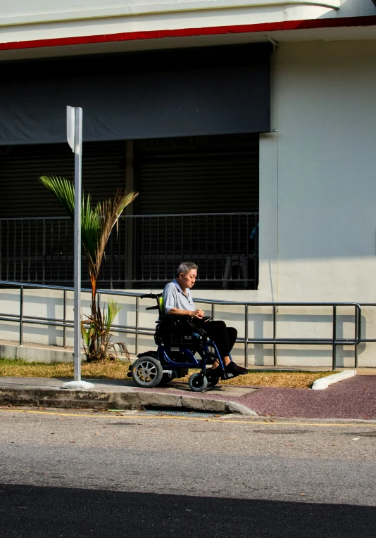 the man is riding his motorized chair