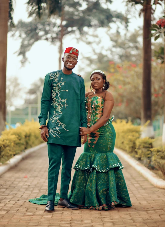 couple pose for wedding picture in front of tree