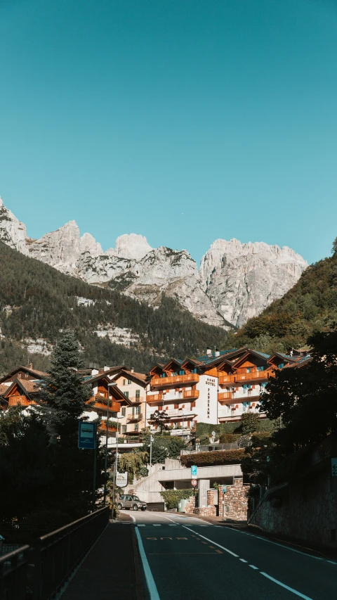 a highway surrounded by mountains and trees with a building on top of it