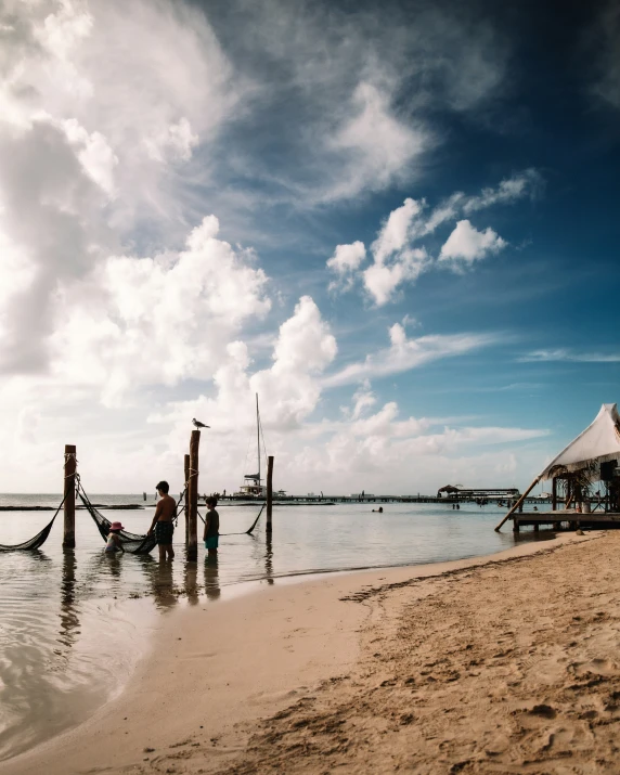 the beach has several posts out in the water