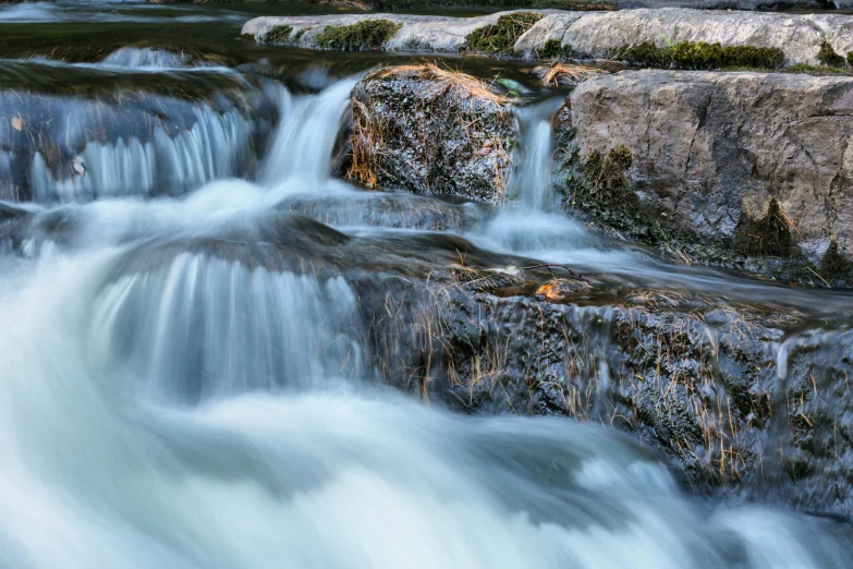 the river has flowing rocks along it