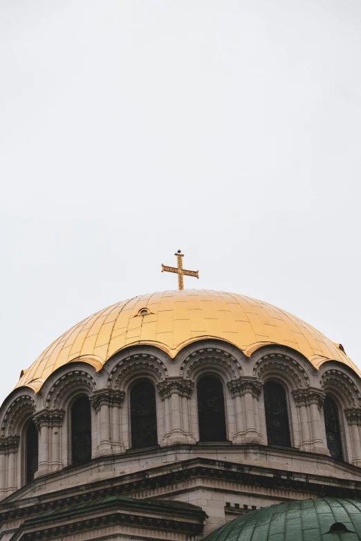 a golden dome on a church with a cross