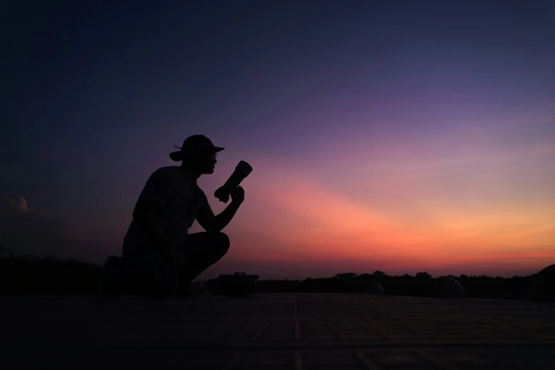 a silhouette of a man holding a baseball bat