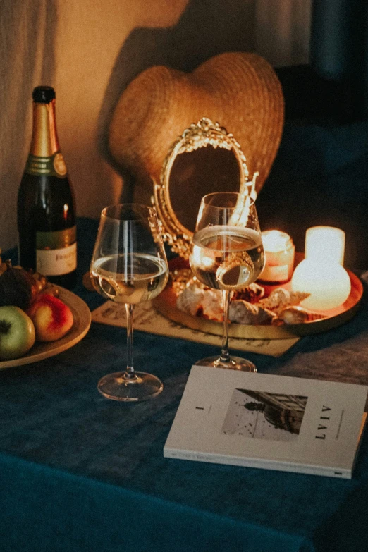 a table topped with glasses and plates of food