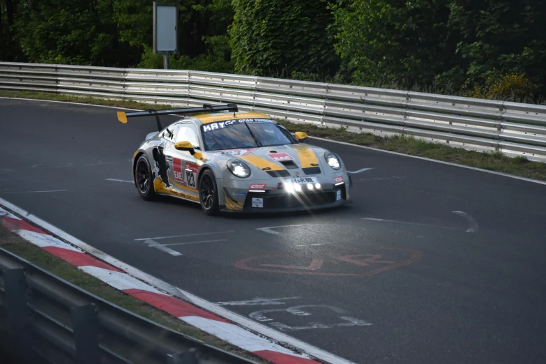 a silver race car making a sharp turn on a road