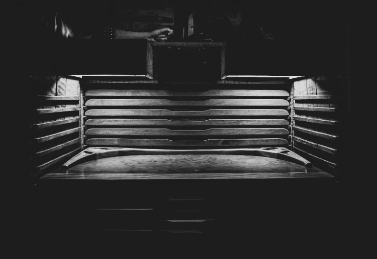 a bench in black and white sitting outside