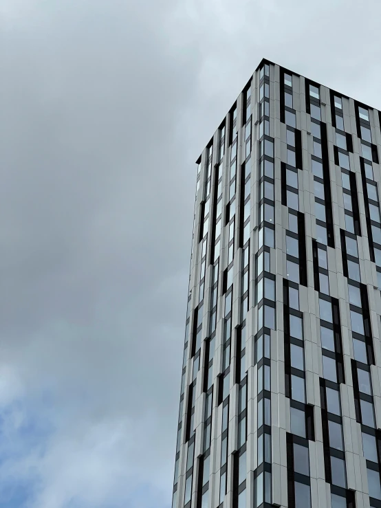 a tall building with windows is against the sky