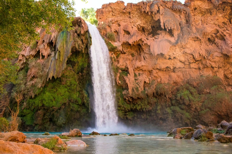 the waterfall is at the top of the rocks