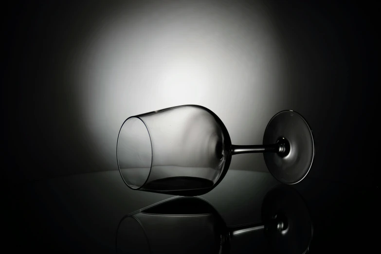 a glass on a table in the dark