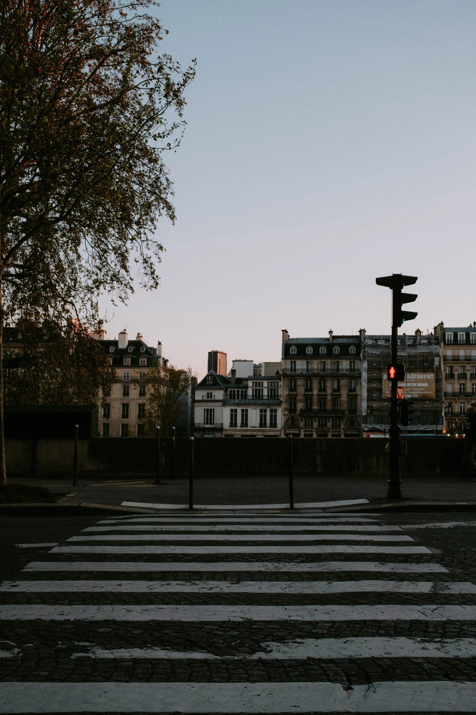 an empty cross walk and some buildings in the back