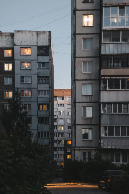 an apartment building with very little windows at dusk