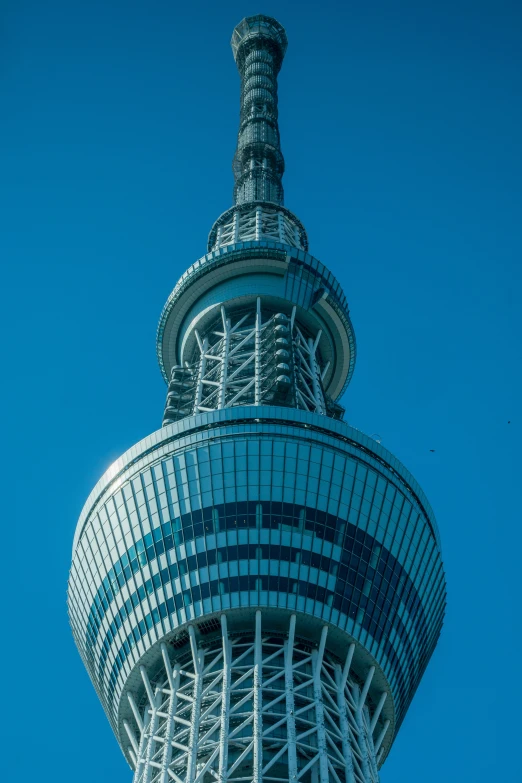 the top of a tall building is seen from below