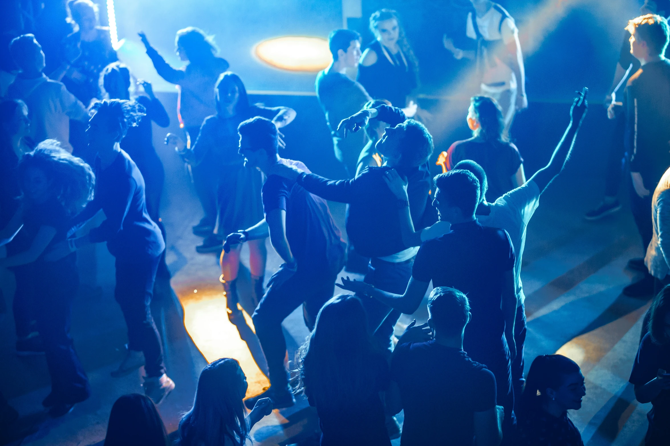 a crowd of people at a dance club