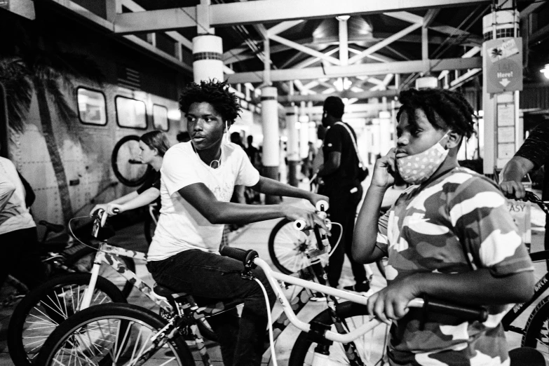 two men are riding their bikes inside