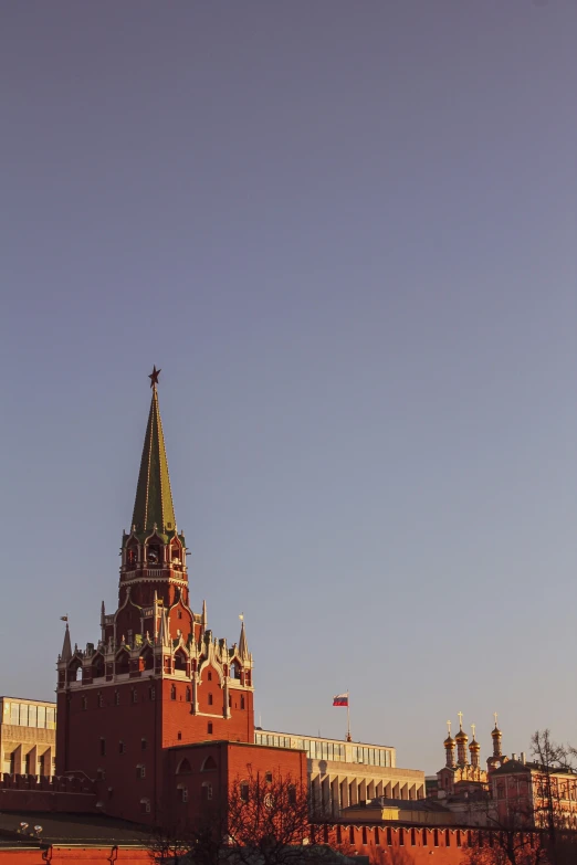 the red brick building is next to a tall clock tower