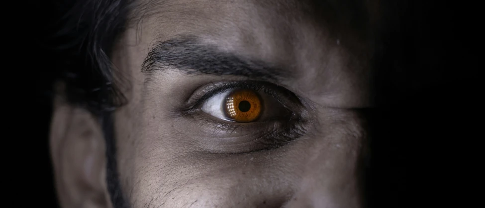 a close - up of an evil looking man's eye