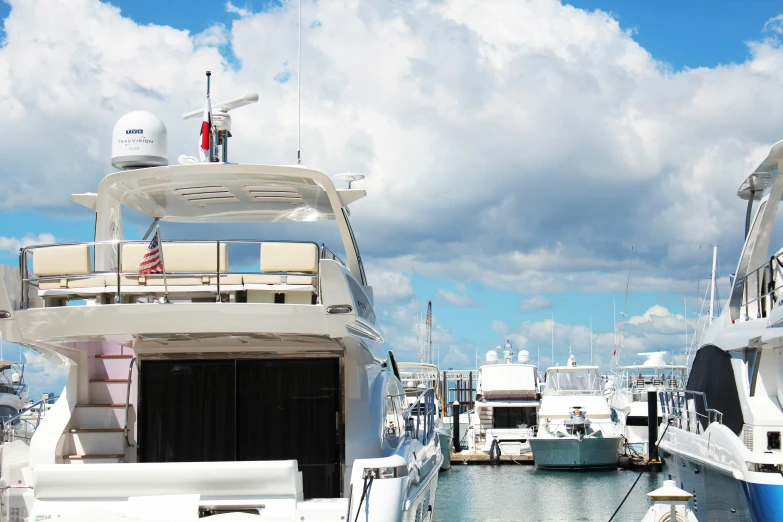 many yachts are parked at the docks while clouds roll by