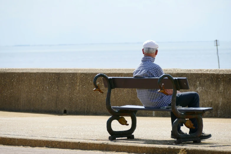 a man is sitting on a park bench