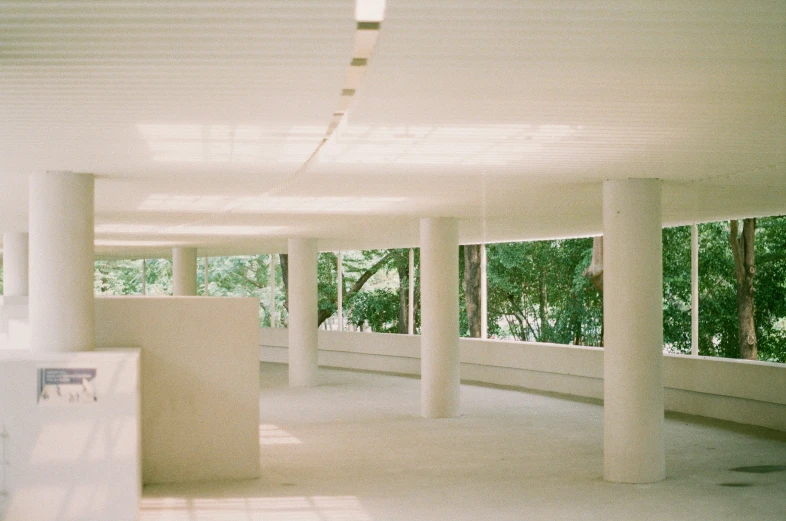 empty room with white floor and glass windows