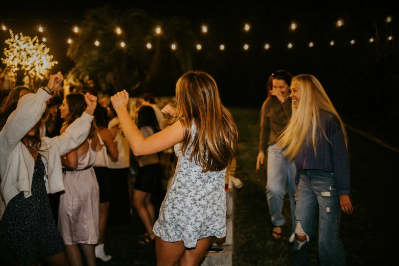 a group of people that are standing in the grass